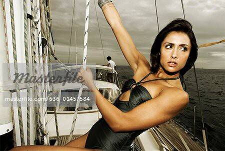 Young-woman-adjusting-rigging-on-sailboat.jpg