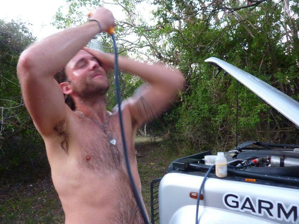 Using-our-hot-shower-for-first-time-on-trip-with-Land-Rover-Defender-110-with-Ov.jpg