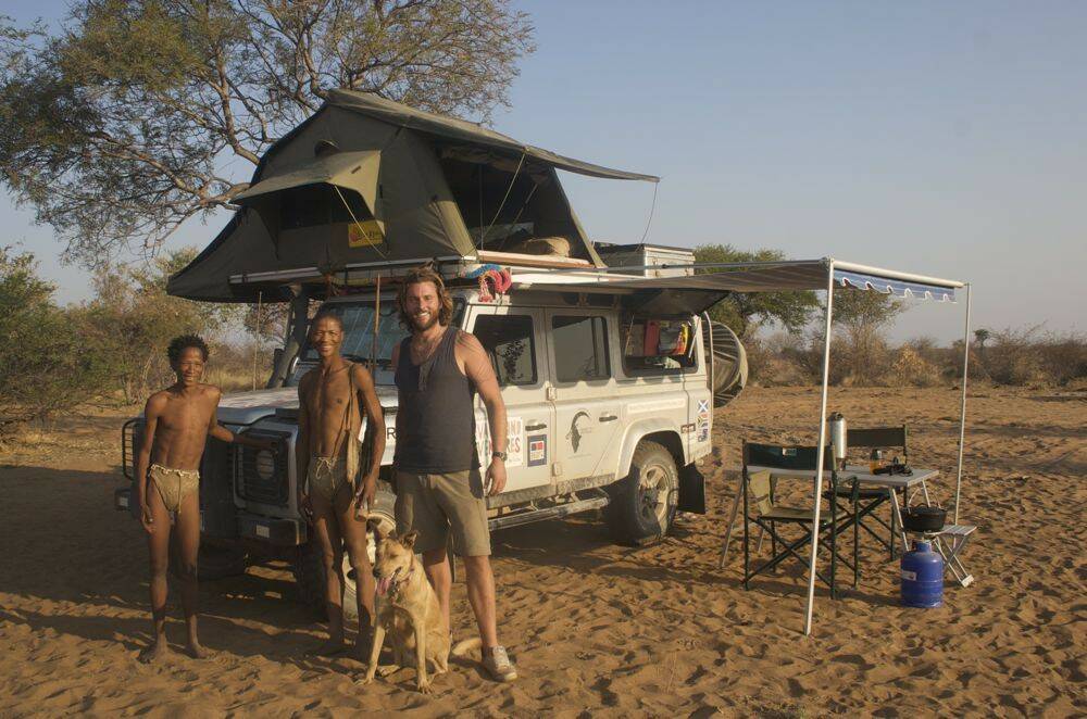 Lachlan-and-Bow-Wow-with-Bushmen-tribe-with-Land-Rover-Defender-110-camp-setup.jpg